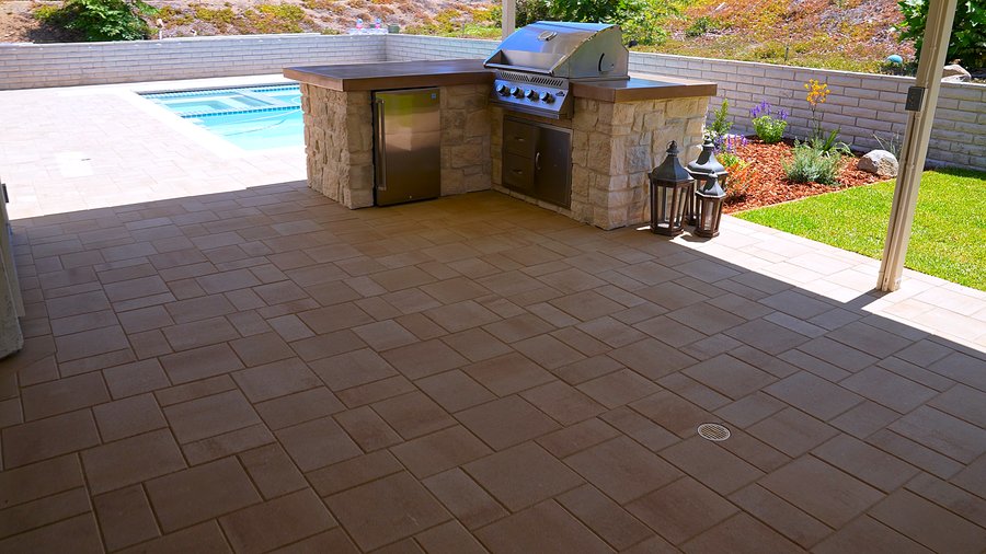 Outdoor kitchen with stone veneer and pergola