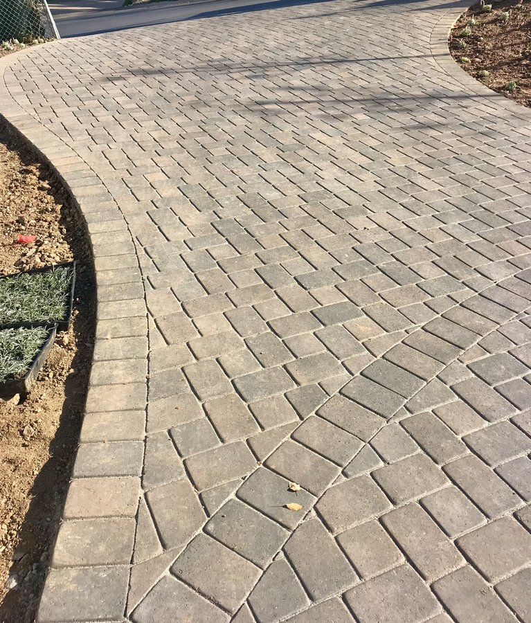 Julian, CA — Belgard driveway, flagstone patios, CMU walls with stone veneer, concrete caps and travertine deck