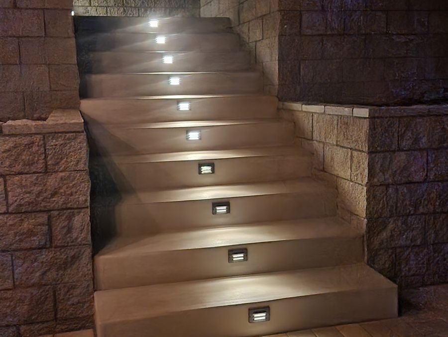 Retaining wall steps with recessed step lighting at night